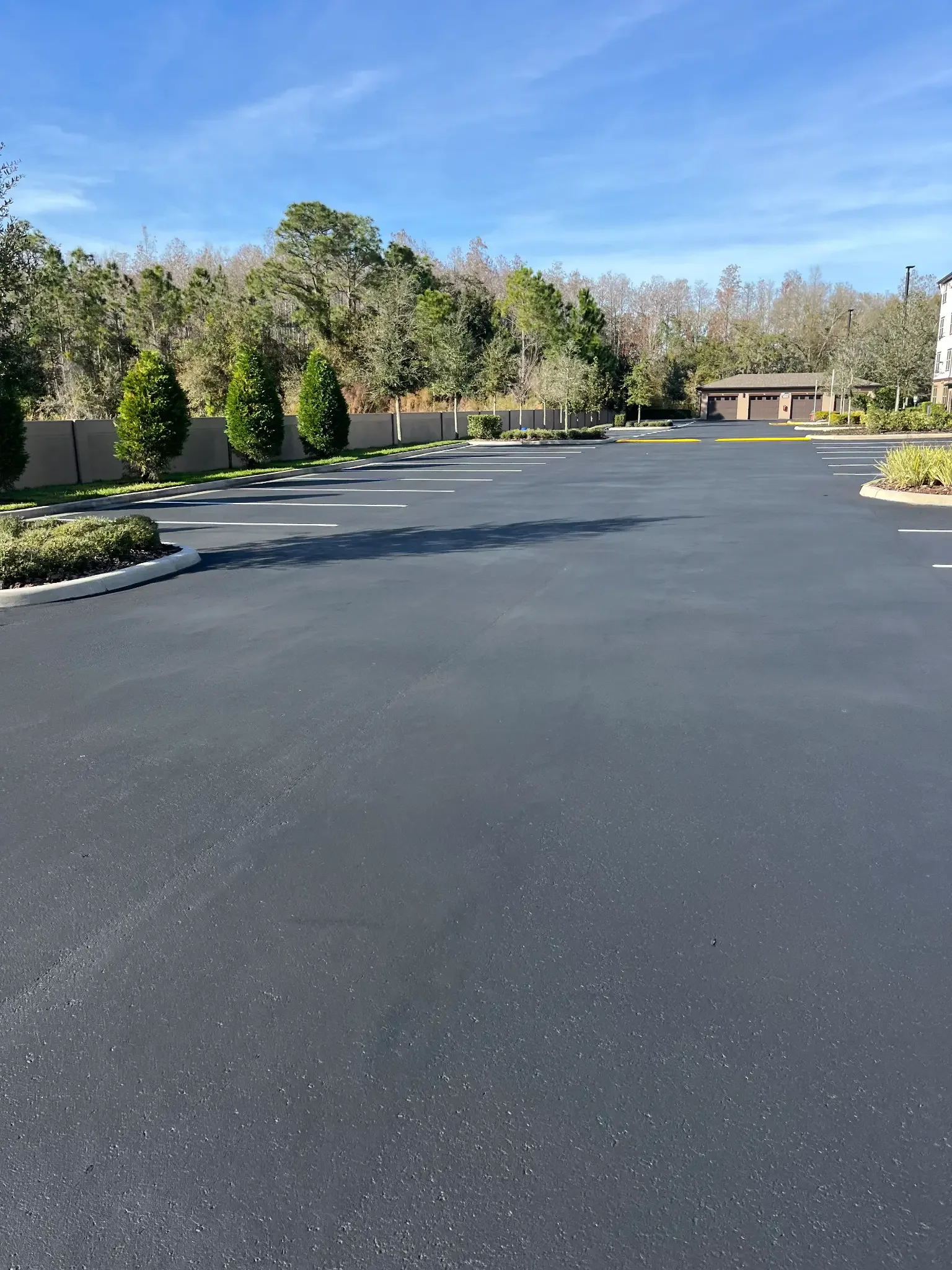 Wide view of a freshly sealcoated and striped parking lot